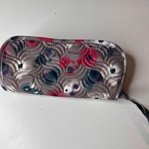Lug clutch wallet features a distinctive quilted pattern and floral print design